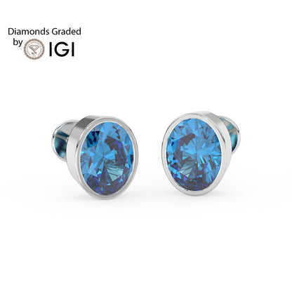 Blue gemstone stud earrings with silver setting on a white background, branded with IGI.